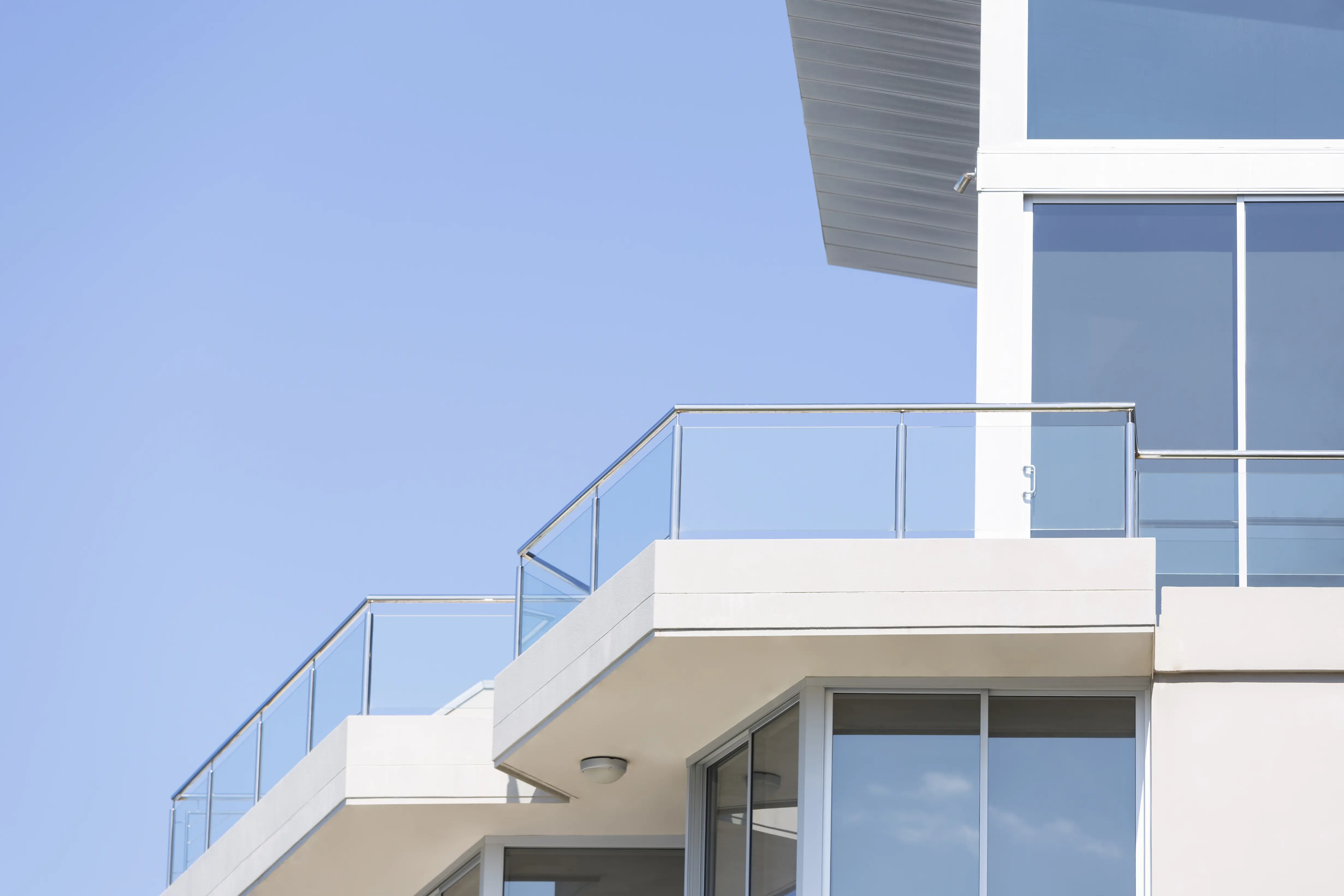 Closeup-modern-apartment-building-against-blue-sky,-copy-space-000075396623_Double.jpg